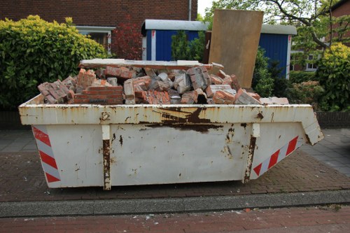 Professionals performing garden clearance with tools in Hornsey