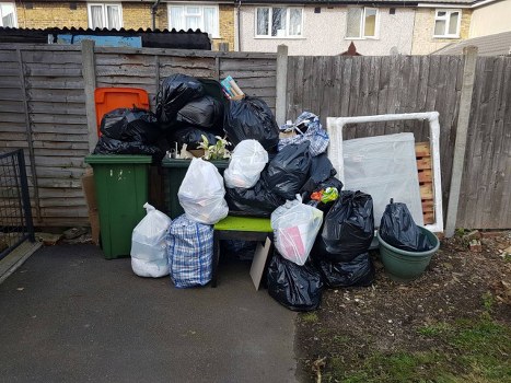 Gardener clearing garden debris in Lisson Grove